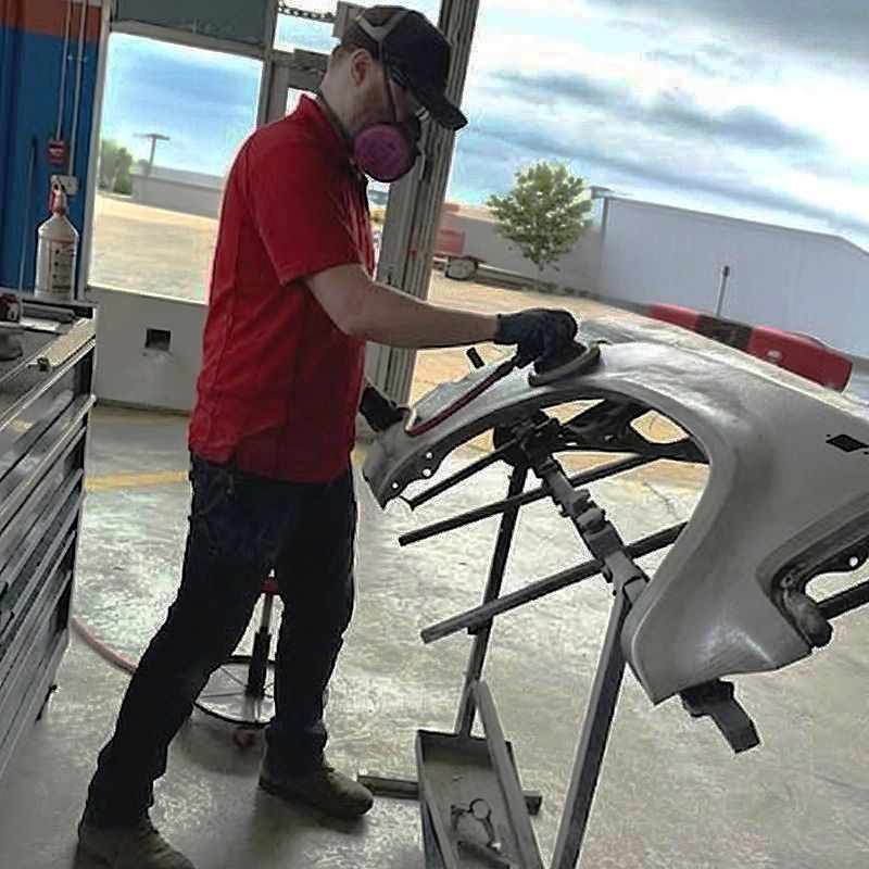 Auto Collision Repair tech sanding bumper